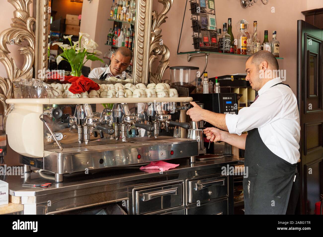 Barista using espresso coffee machine in cafe, Sardinia, Italy Stock Photo
