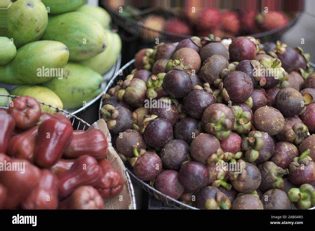 Baskets with a variety of exotic fruits in the Asian market Stock Photo