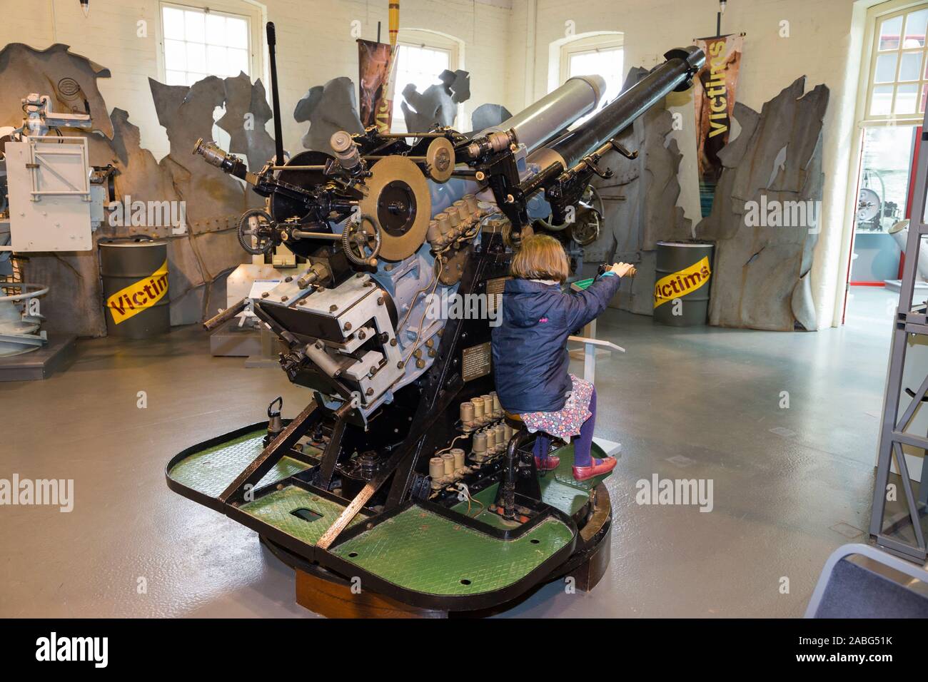 Young children allowed to examine the 4-inch naval Submarine Gun Mk XXIII Mark 23 on display at the Explosion Museum of Naval Firepower; the Royal Navy's former armaments depot of Priddy's Hard, Gosport near Portsmouth, UK. (105) Stock Photo
