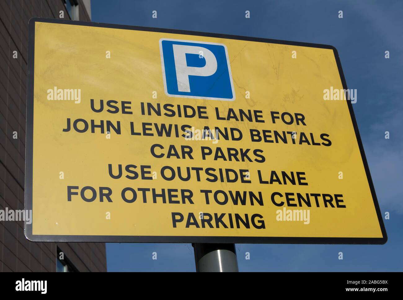 road sign in kingston, surrey, england, indicating lane use for local shopping parking with misspelling of bentalls as bentals Stock Photo