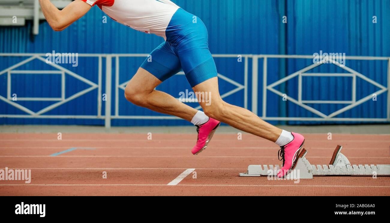 start sprint running from starting blocks male athlete Stock Photo Alamy