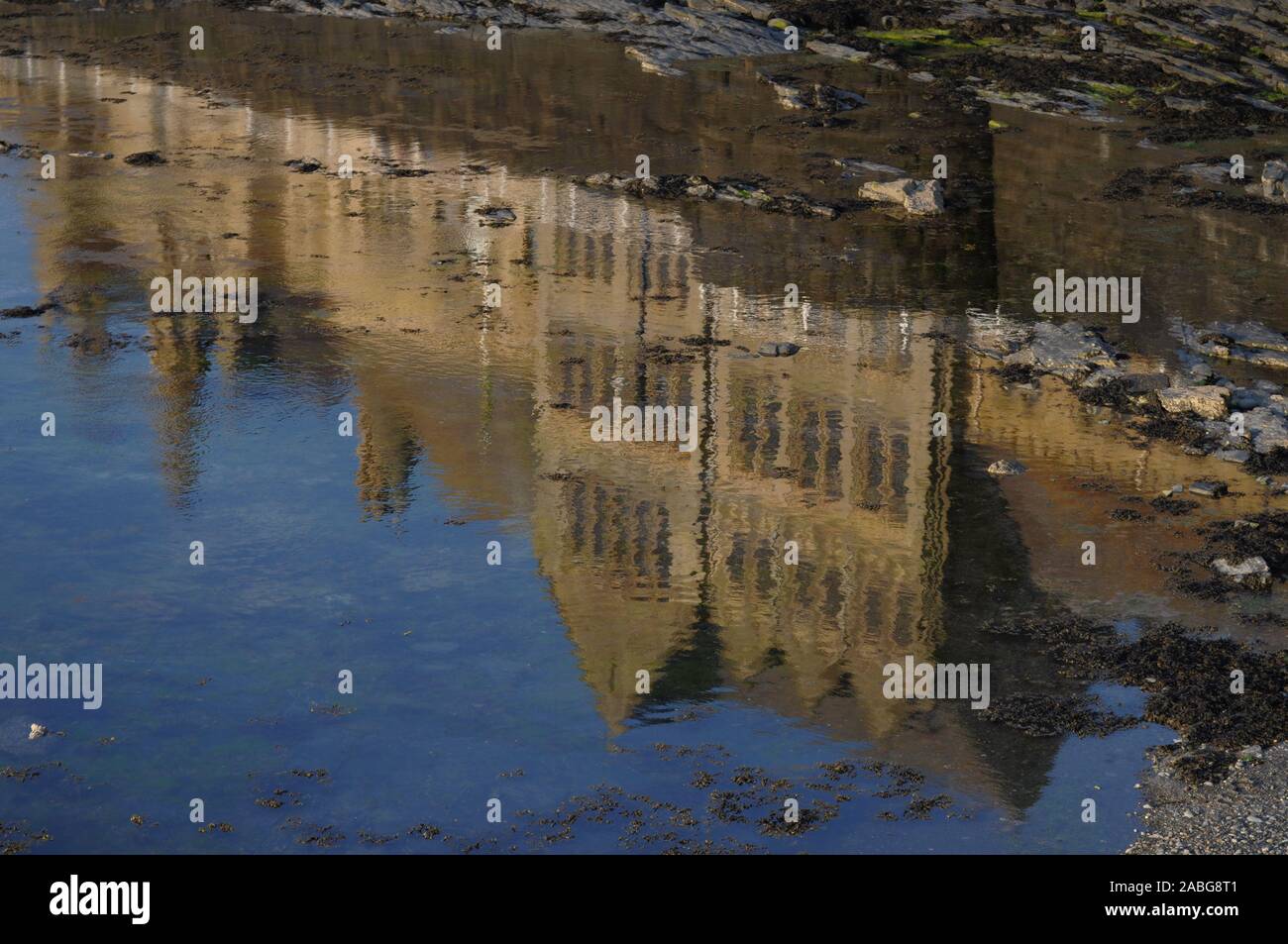 Aberystwyth Ceredigion/UK July 02 2018: Reflection of the Old College building, Marine Terrace, in the sea at low tide. Stock Photo