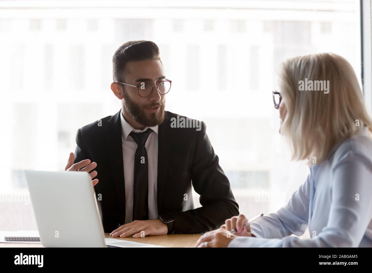 Diverse businesspeople talk discussing ideas at meeting Stock Photo