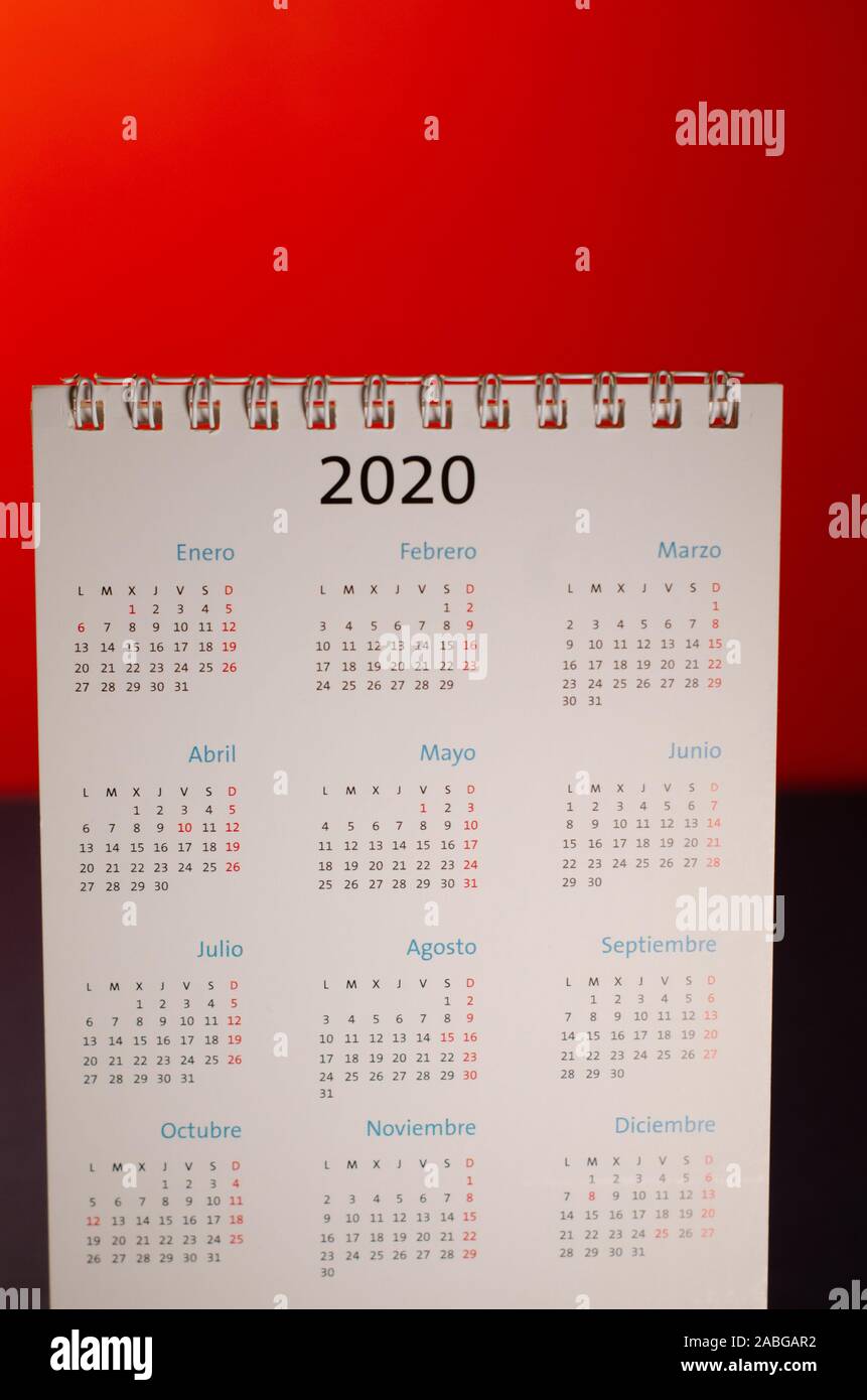 New Year 2020 calendar on desk, red illuminated background. Planning, organizing the new year, months of the new year. Front view of the object with e Stock Photo