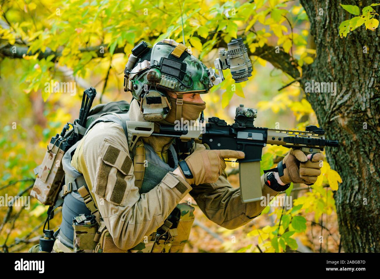 Airsoft Man In Uniform With Machine Gun And Night Vision Device On