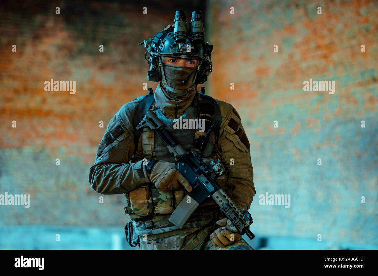 Airsoft man in uniform with machine gun and nightvision device on