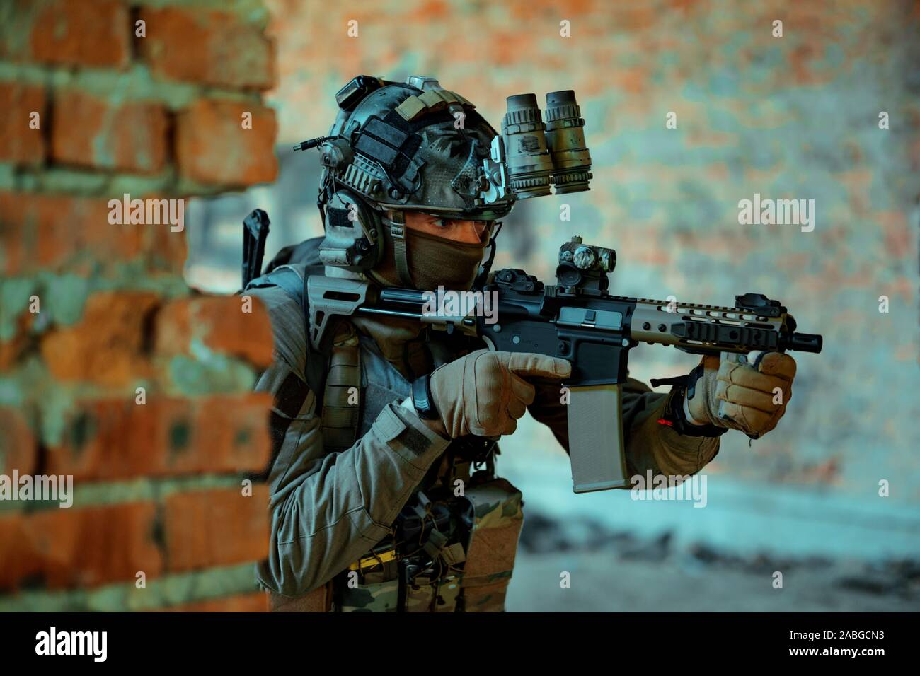 Airsoft man in uniform with machine gun and nightvision device on