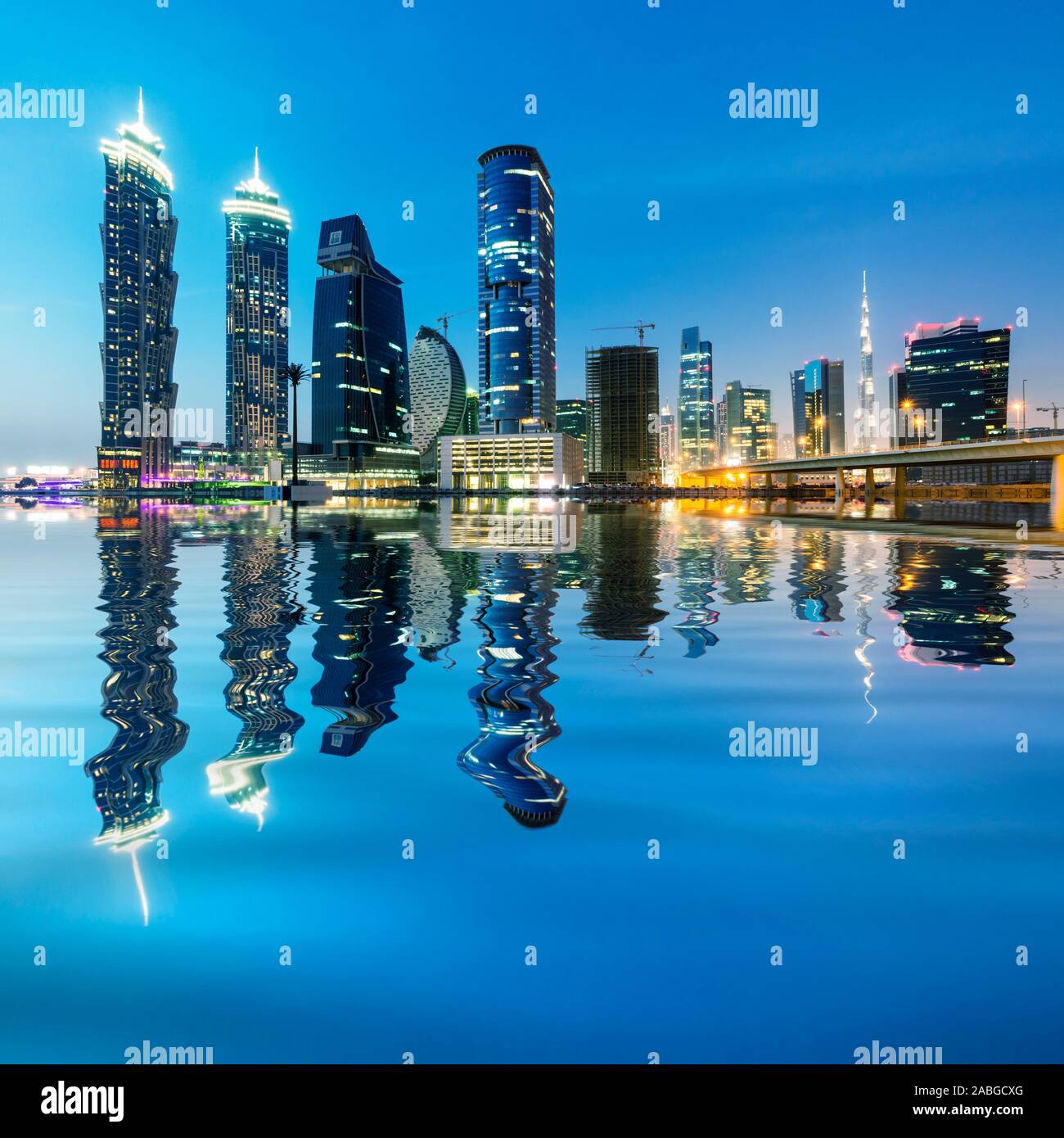Futuristic skyline at night of new skyscrapers at Business Bay in Dubai United Arab Emirates Stock Photo