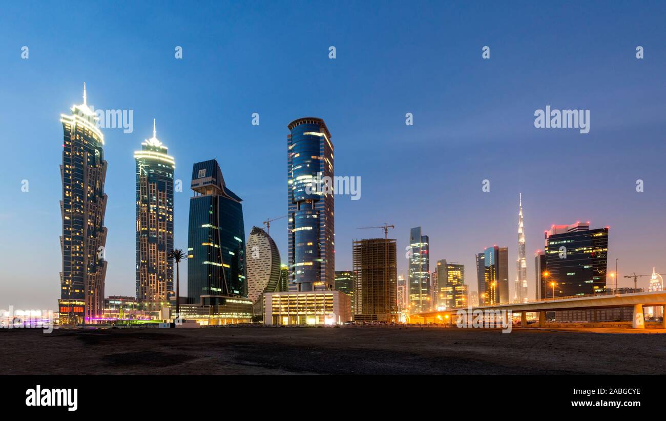 Futuristic skyline at night of new skyscrapers at Business Bay in Dubai United Arab Emirates Stock Photo