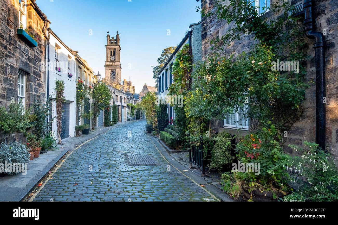View along traditional row of mews houses towards St Stephen's Church in Circus Lane in Stockbridge district of New Town in Edinburgh, Scotland, Unite Stock Photo