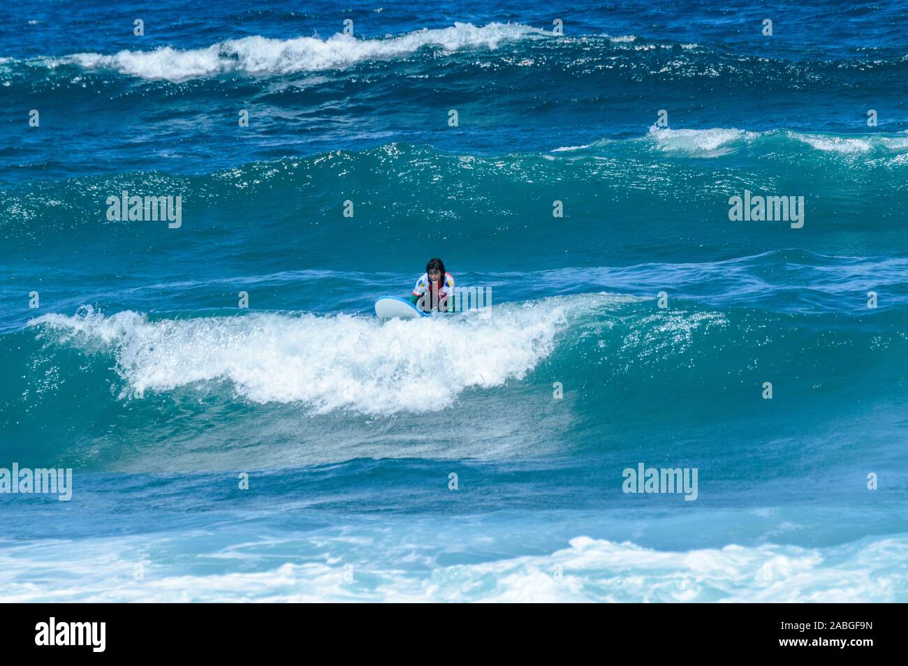 Long Haired Brunette Woman Catching Waves On Las Americas Beach. April 11, 2019. Santa Cruz De Tenerife Spain Africa. Travel Tourism Street Photograph Stock Photo