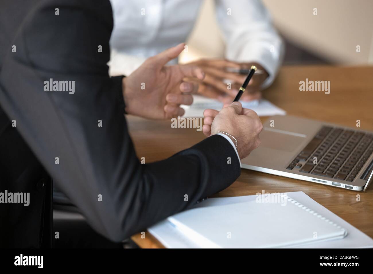 Close up of diverse businesspeople cooperating at meeting Stock Photo