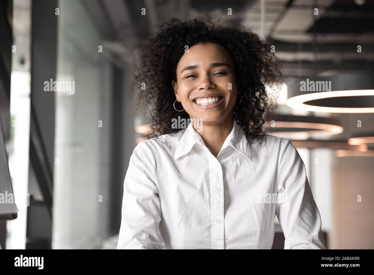 Headshot Portrait Of Happy Biracial Female Employee In Office