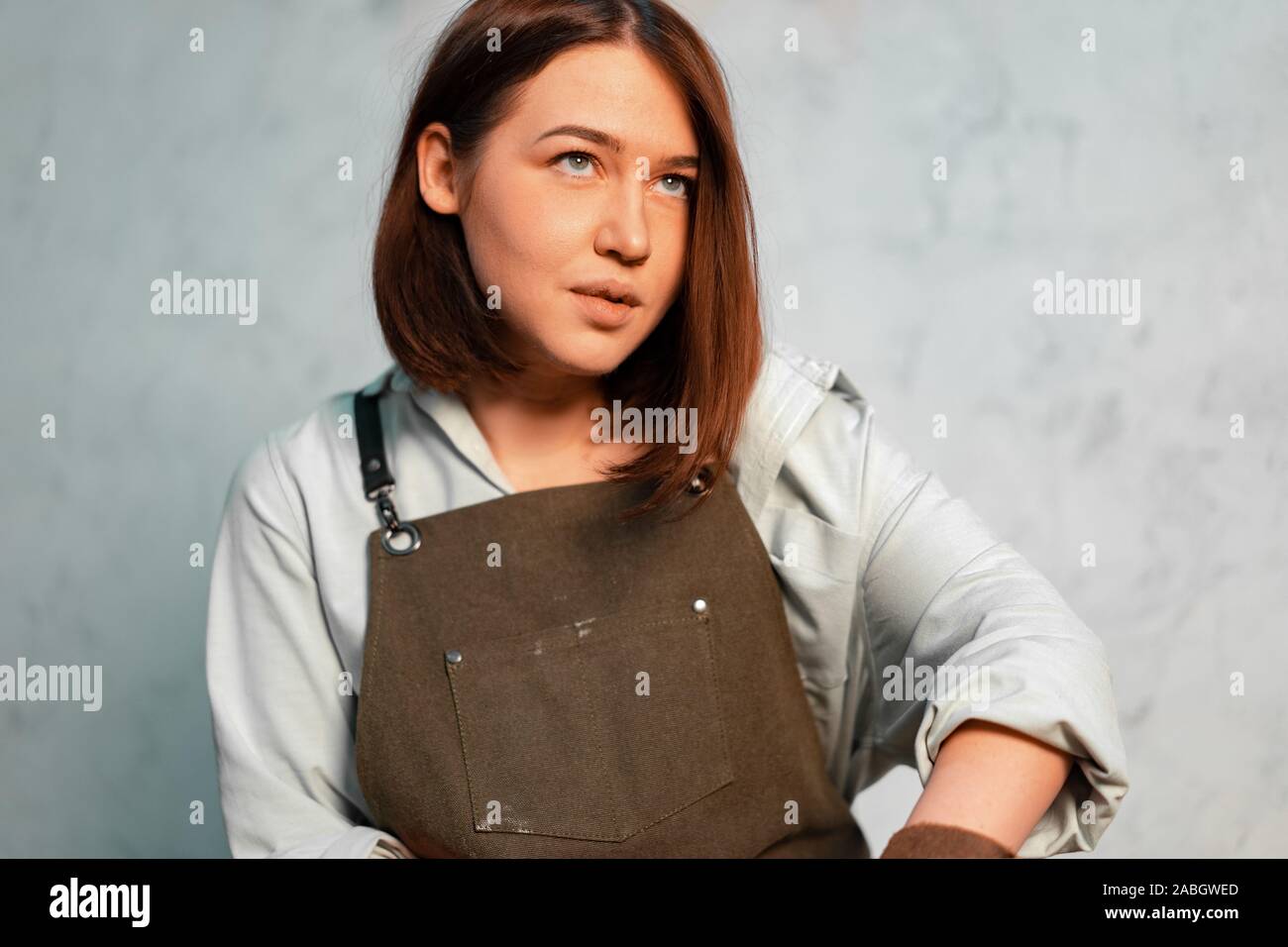 Young Beautiful Creative Girl Learning How to Make Ceramics on Workshop. Stock Photo