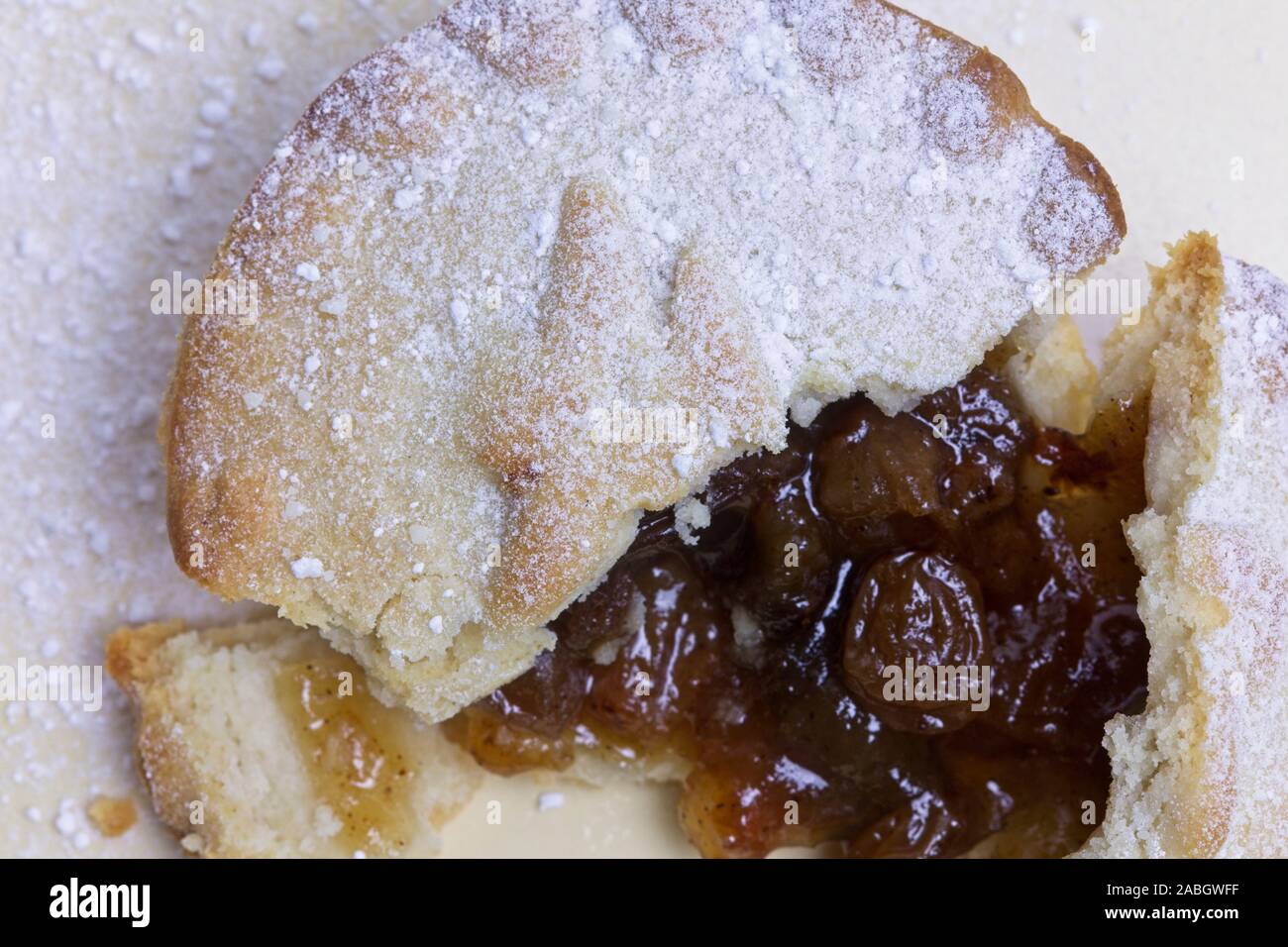 Deep filled mince pie cut open with a dusting of icing sugar Stock Photo