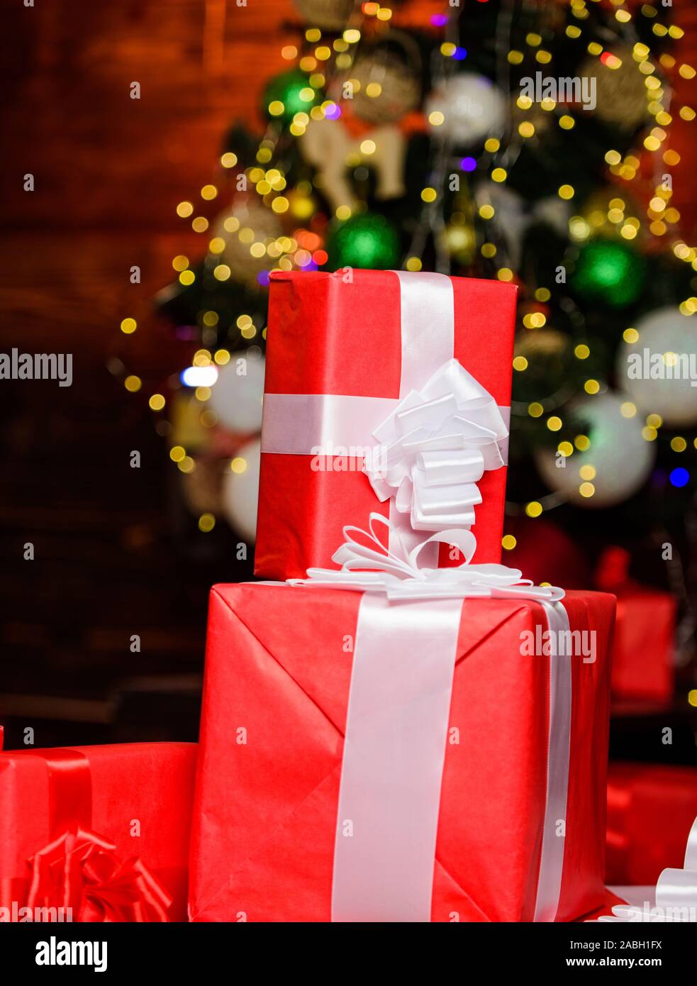 Christmas online shopping. present boxes at christmas tree. happy new year. celebrate xmas at home. winter holiday shopping. shopping sales. gift delivery. surprise from santa. Stock Photo