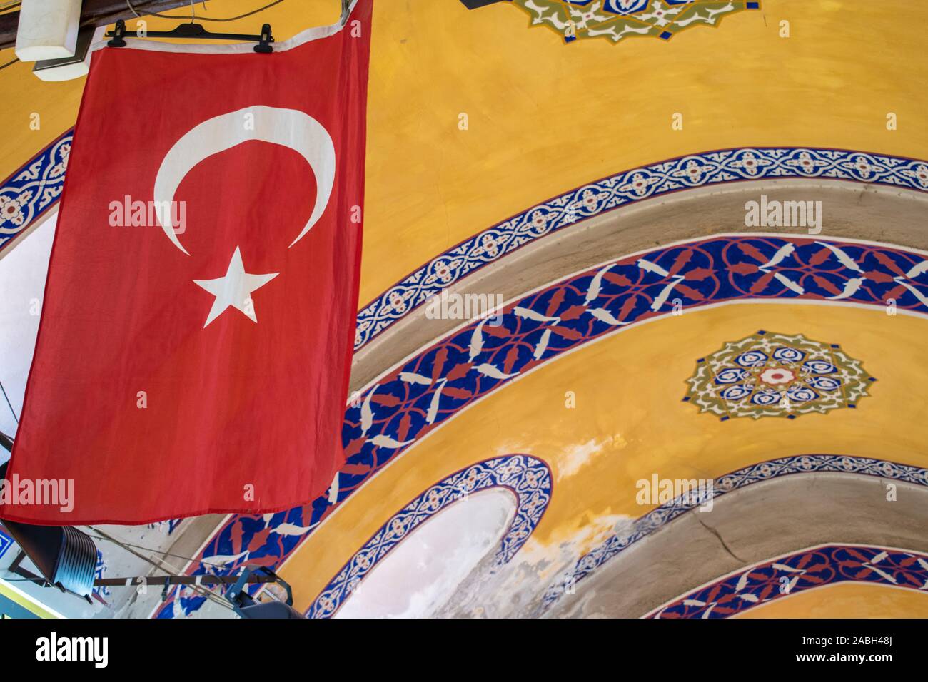 Istanbul: turkish flag and ceiling decorations in the Grand Bazaar, one of the largest and oldest covered markets in the world with over 4,000 shops Stock Photo