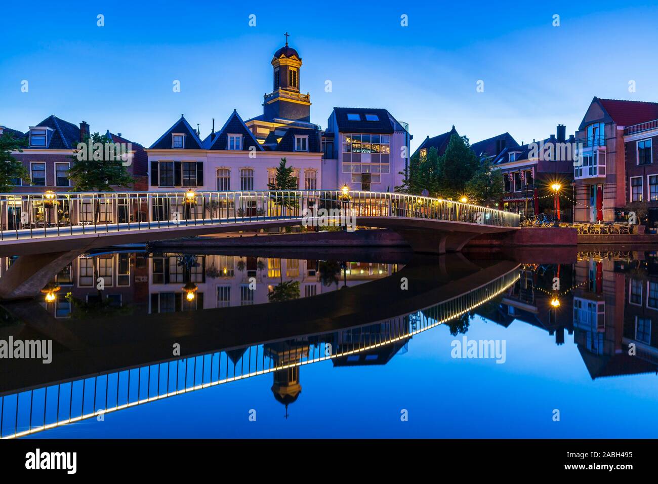 Traditional Dutch culture architecture houses and canal during the blue hour. Historical and touristic town Leiden, the Netherlands Stock Photo