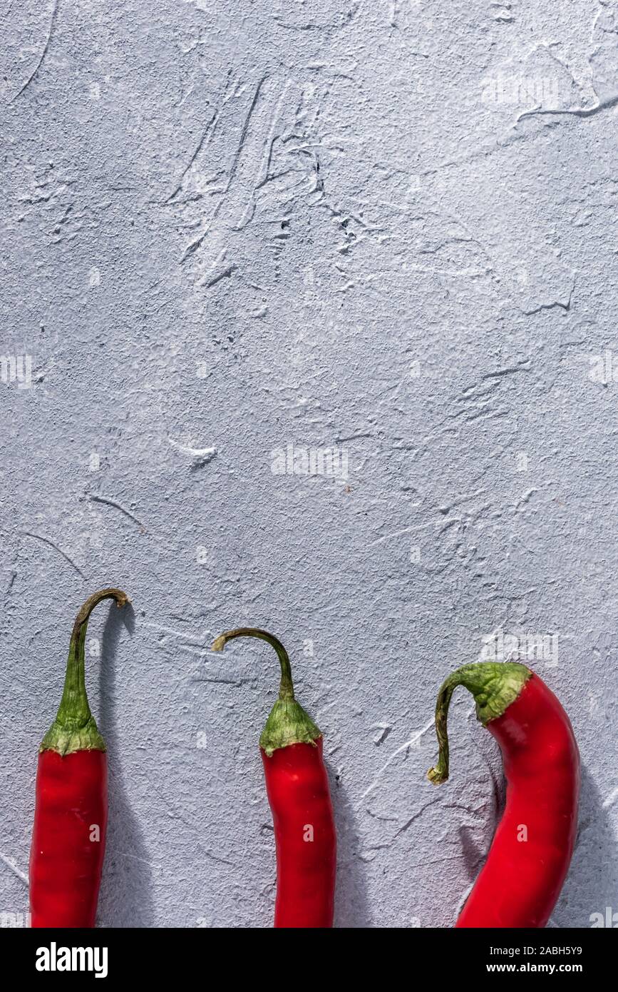 red hot chili peppers on a gray stone background Stock Photo - Alamy