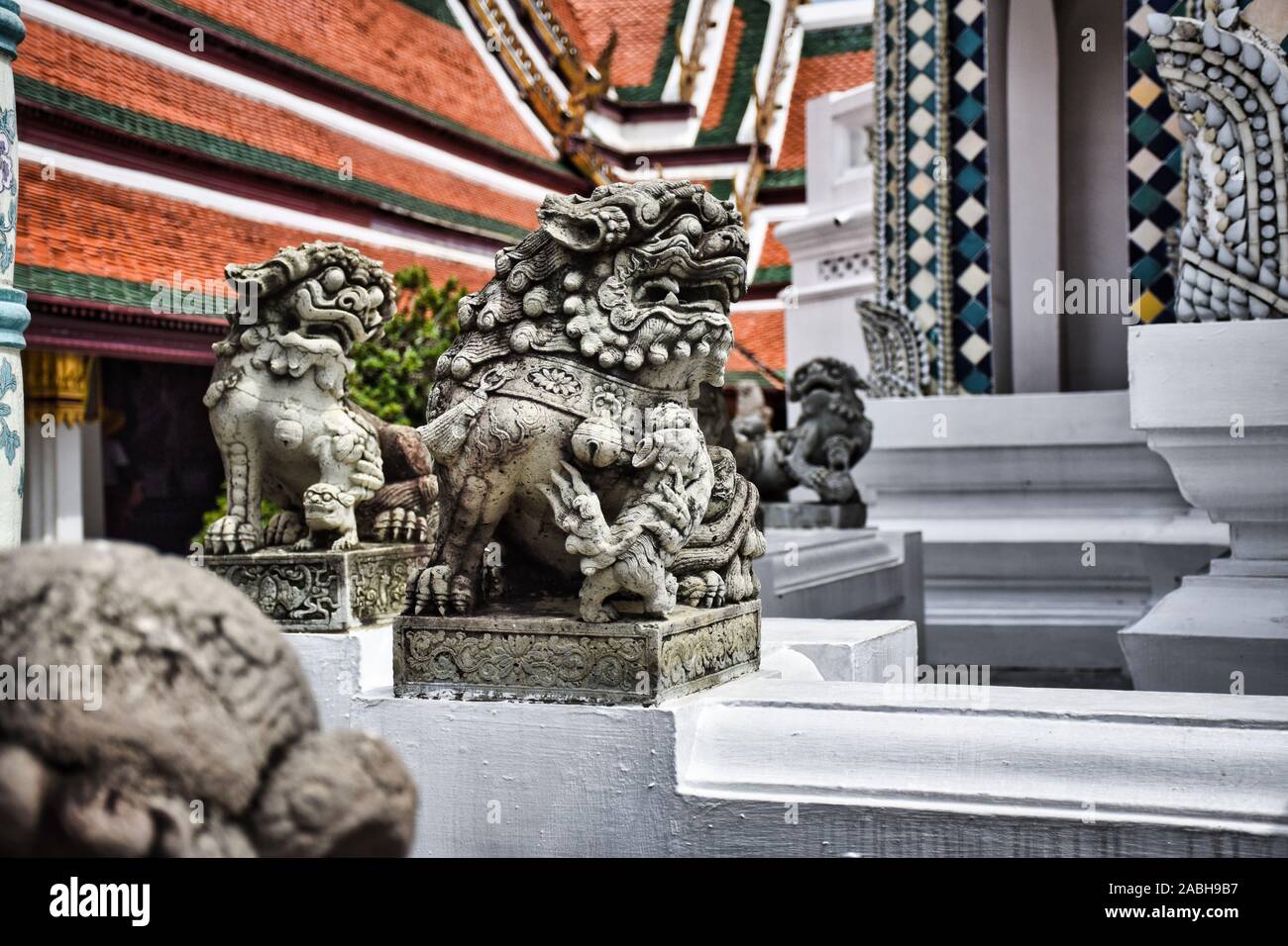 Traditional guardian stone Thai Qilin sculptures in The Grand Palace of Bangkok. In Thailand known as Gilen and is a member of the pantheon of Thai Hi Stock Photo