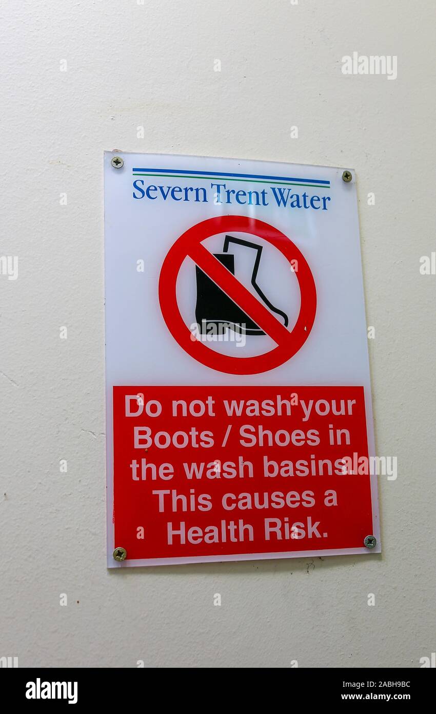 A sign saying do not wash boots or shoes in the wash basins as this causes a health risk, England, UK Stock Photo