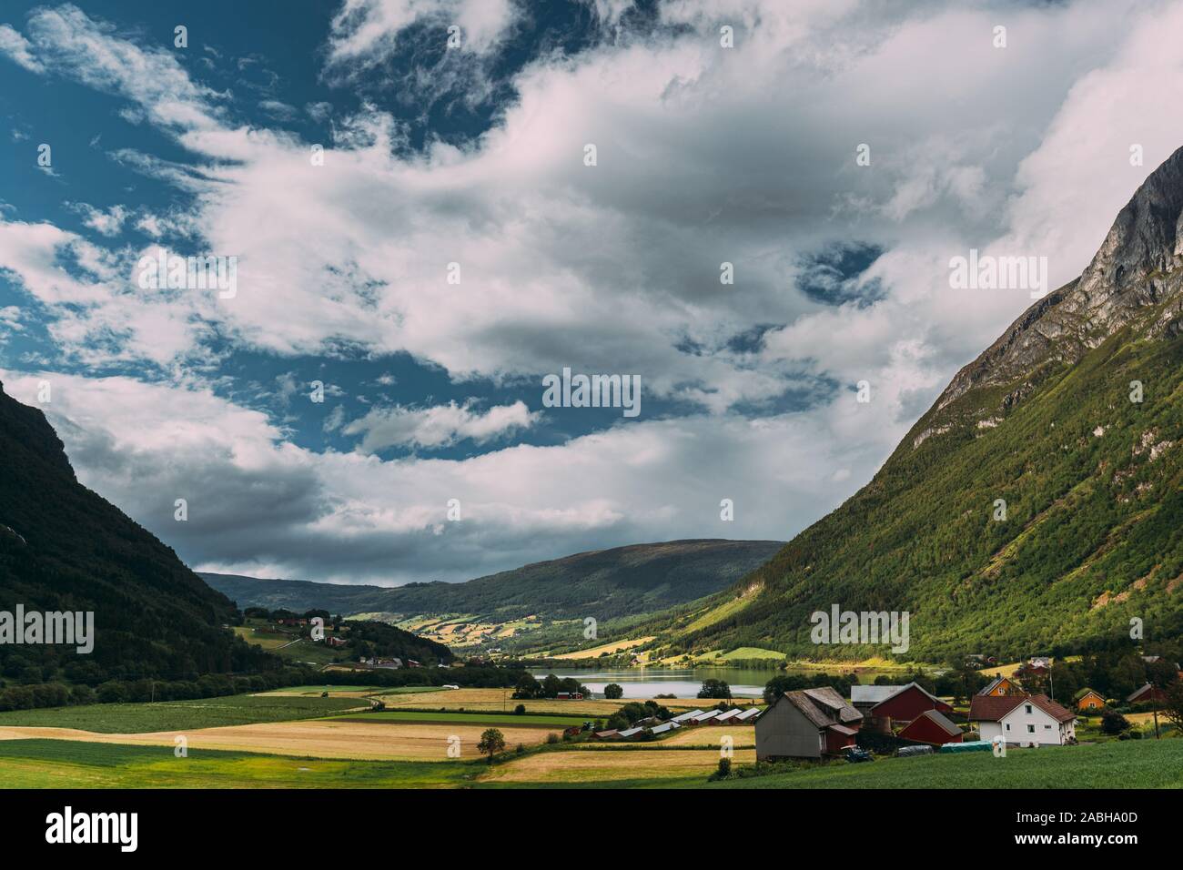 Byrkjelo Village, Sogn Og Fjordane County, Norway. Beautiful Sky Above Norwegian Rural Landscape. Bergheimsvatnet Lake In Summer Day. Agricultural And Stock Photo
