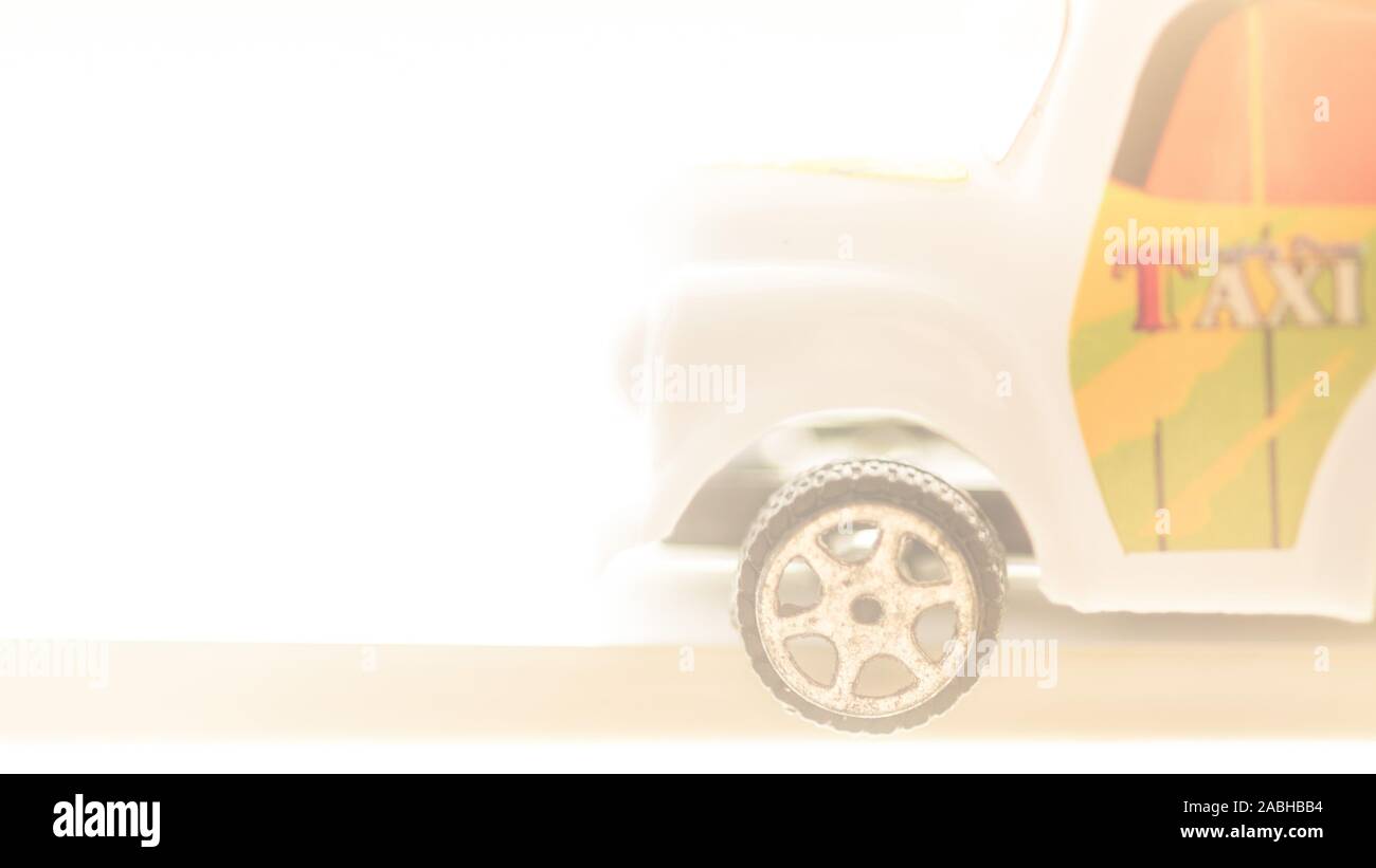 white car toy taxi in bright light road. Stock Photo