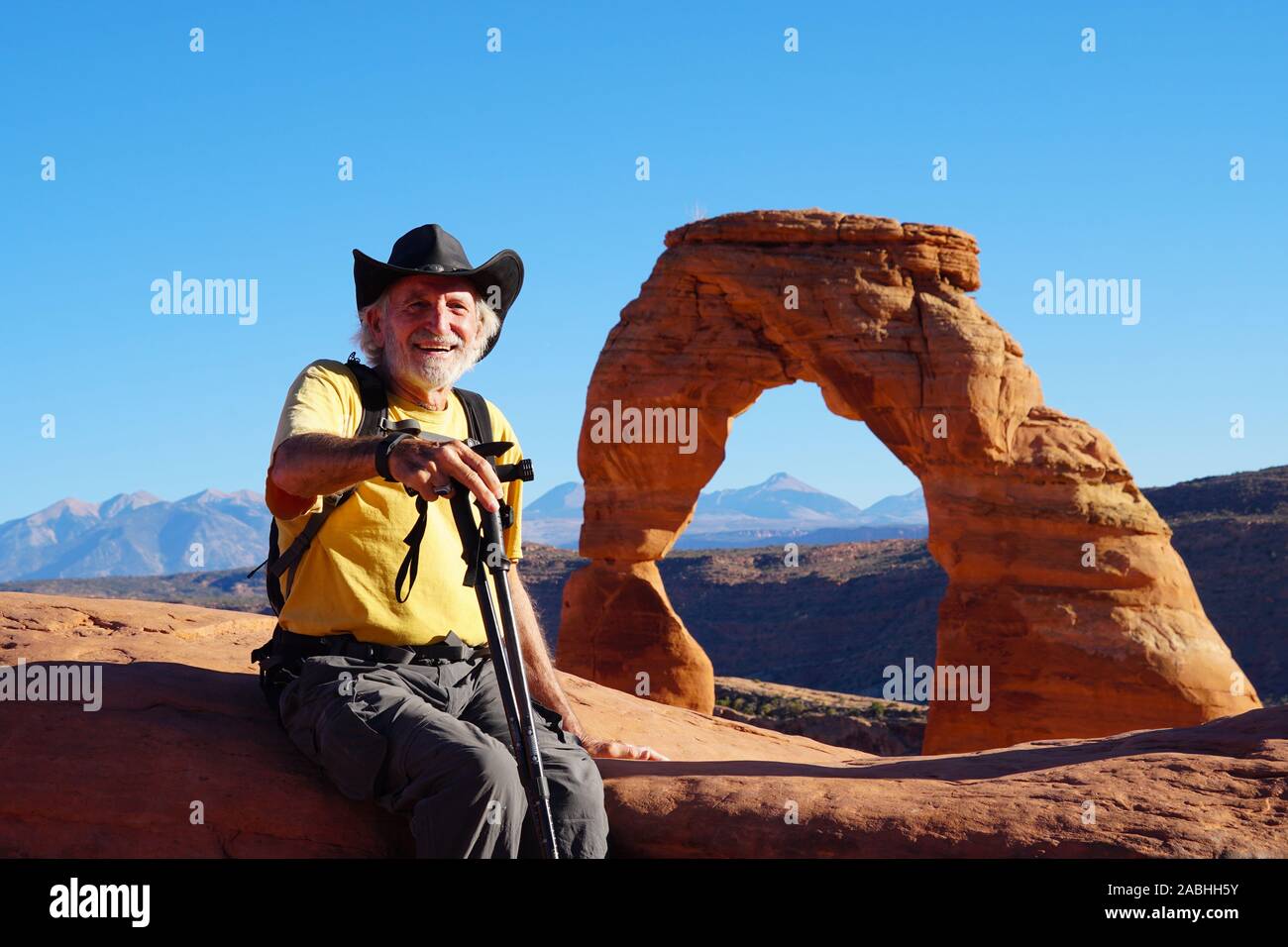 A senior hiker enjoying the views from the Delicate Arch area of Arches National Park. Stock Photo