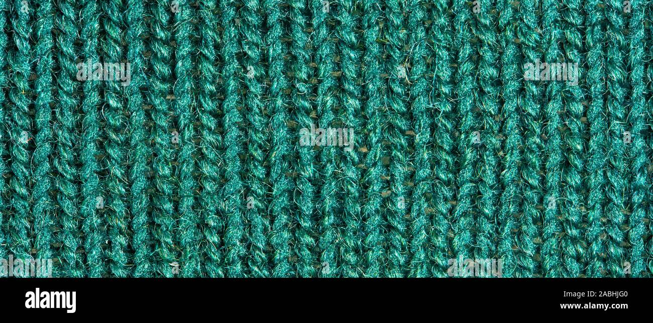 Green knitting wool texture. Cloth background close up Stock Photo