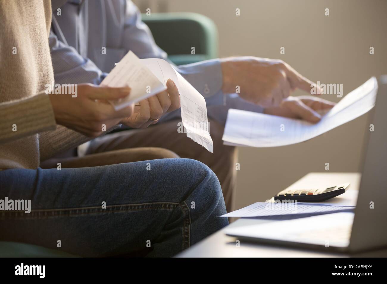 Spouses manage family budget check bills cheques closeup cropped image Stock Photo