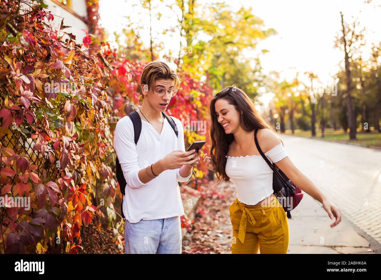 Happy joyful young couple laughing holding phone talking about funny online joke, using humorous app or watching internet mobile video having fun with Stock Photo - Alamy Happy joyful young couple laughing holding phone talking about funny online joke, using humorous app or watching internet mobile video having fun with Stock Photo - Alamy