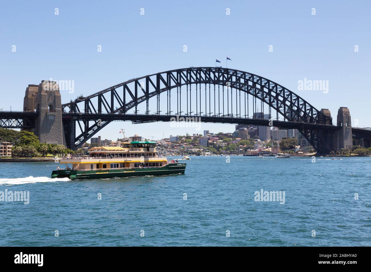 Sydney Harbour Bridge; a ferry passes in front of the bridge on a sunny day in spring; Sydney Harbour, Sydney Australia Stock Photo