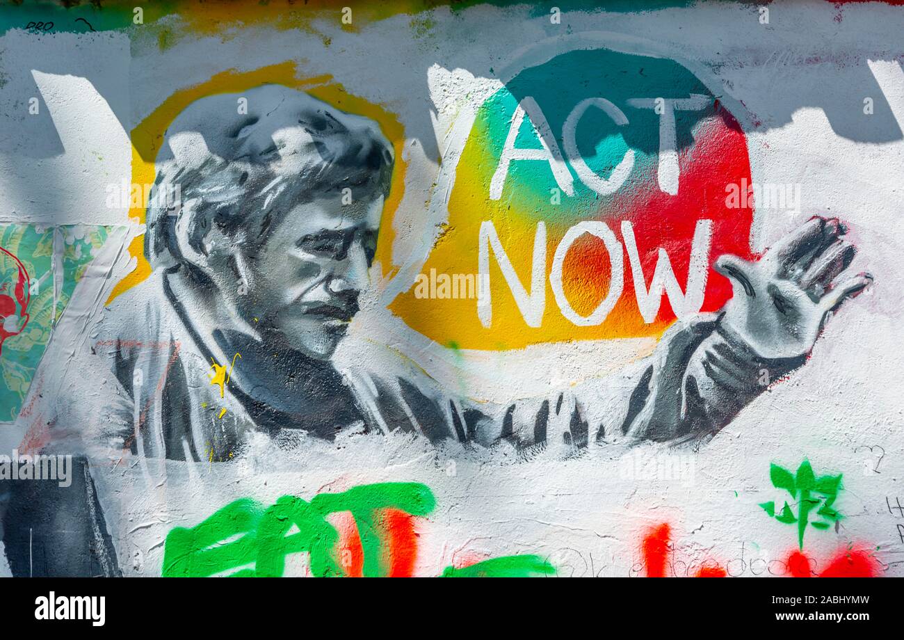 Act Now, colorful graffiti on the John Lennon Wall, Prague, Bohemia, Czech Republic Stock Photo
