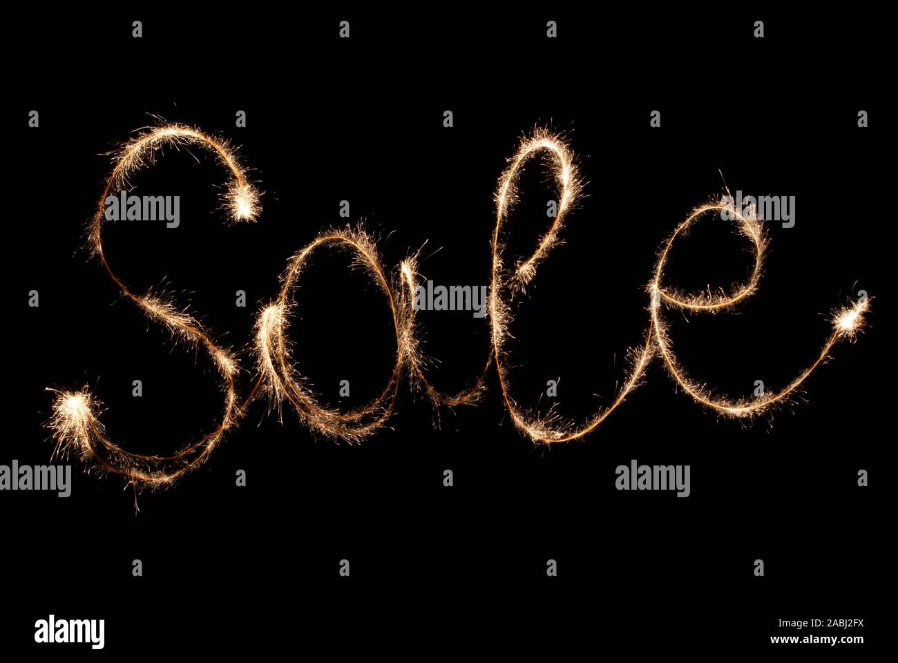 Inscription shiny sparklers - sale on a black background. Stock Photo