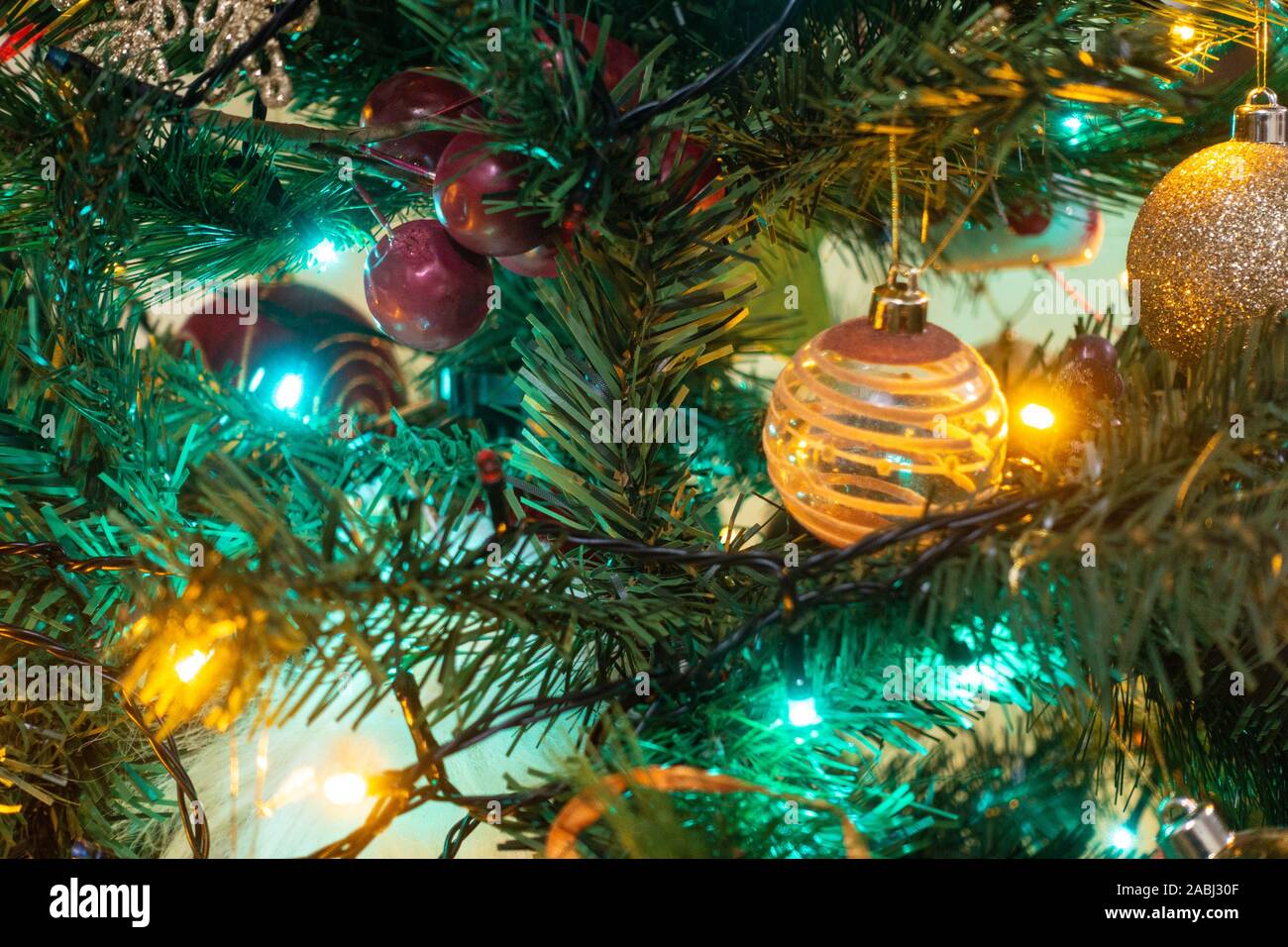 Colourful fairy lights and baubles decorate a Christmas tree Stock Photo Alamy