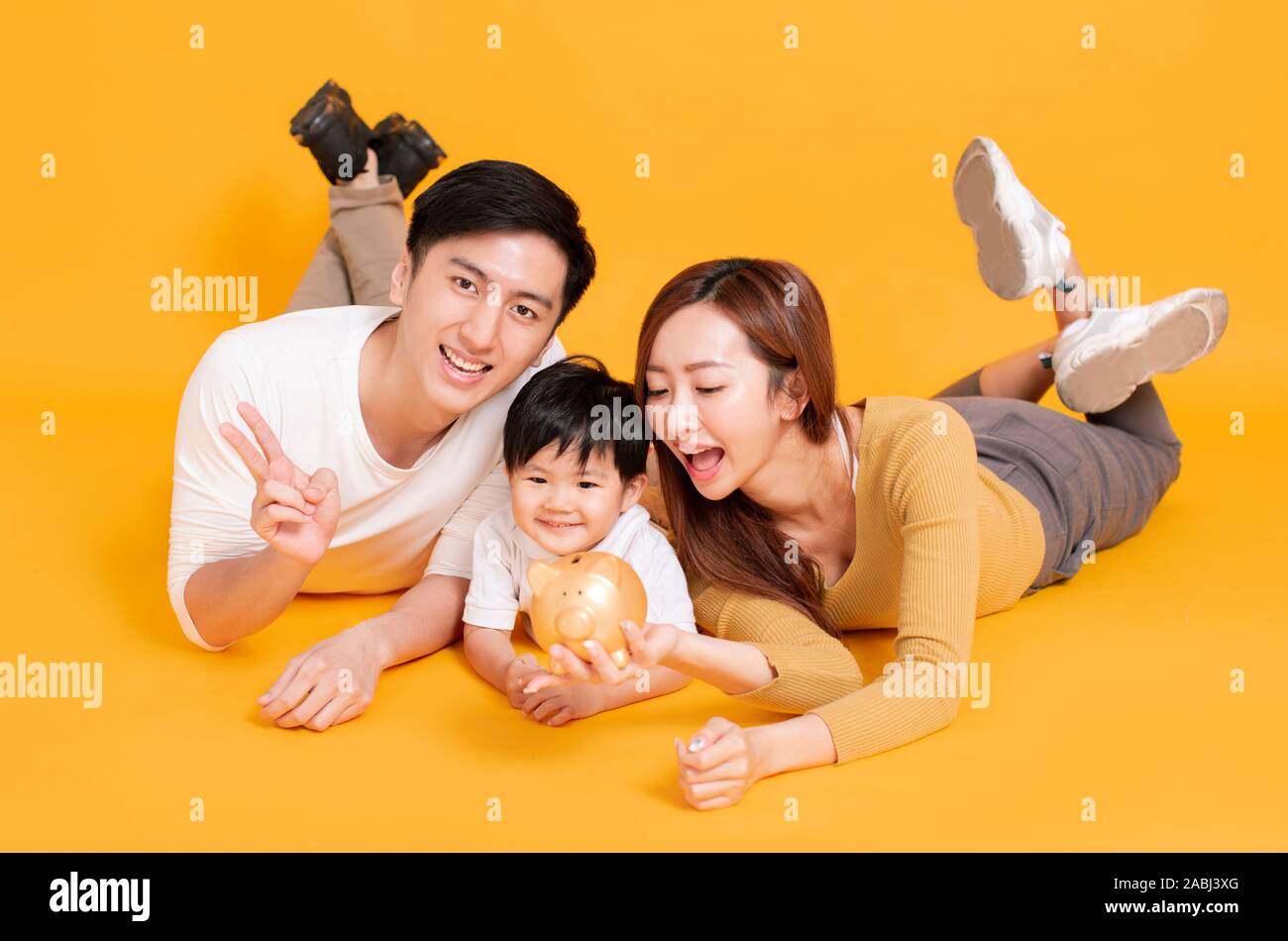 happy young family holding piggy bank Stock Photo