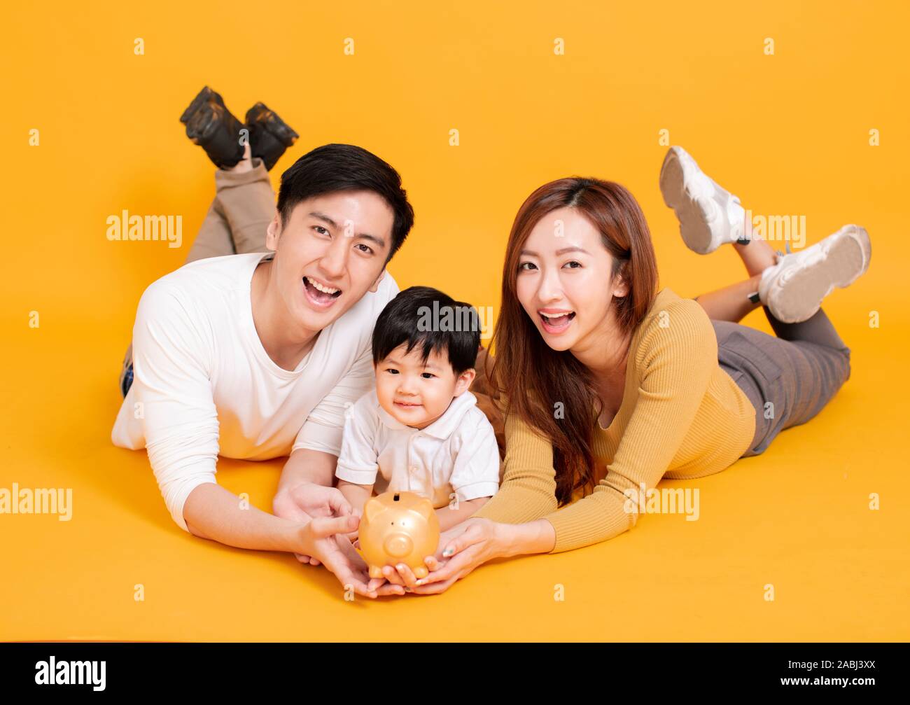 happy young family holding piggy bank Stock Photo