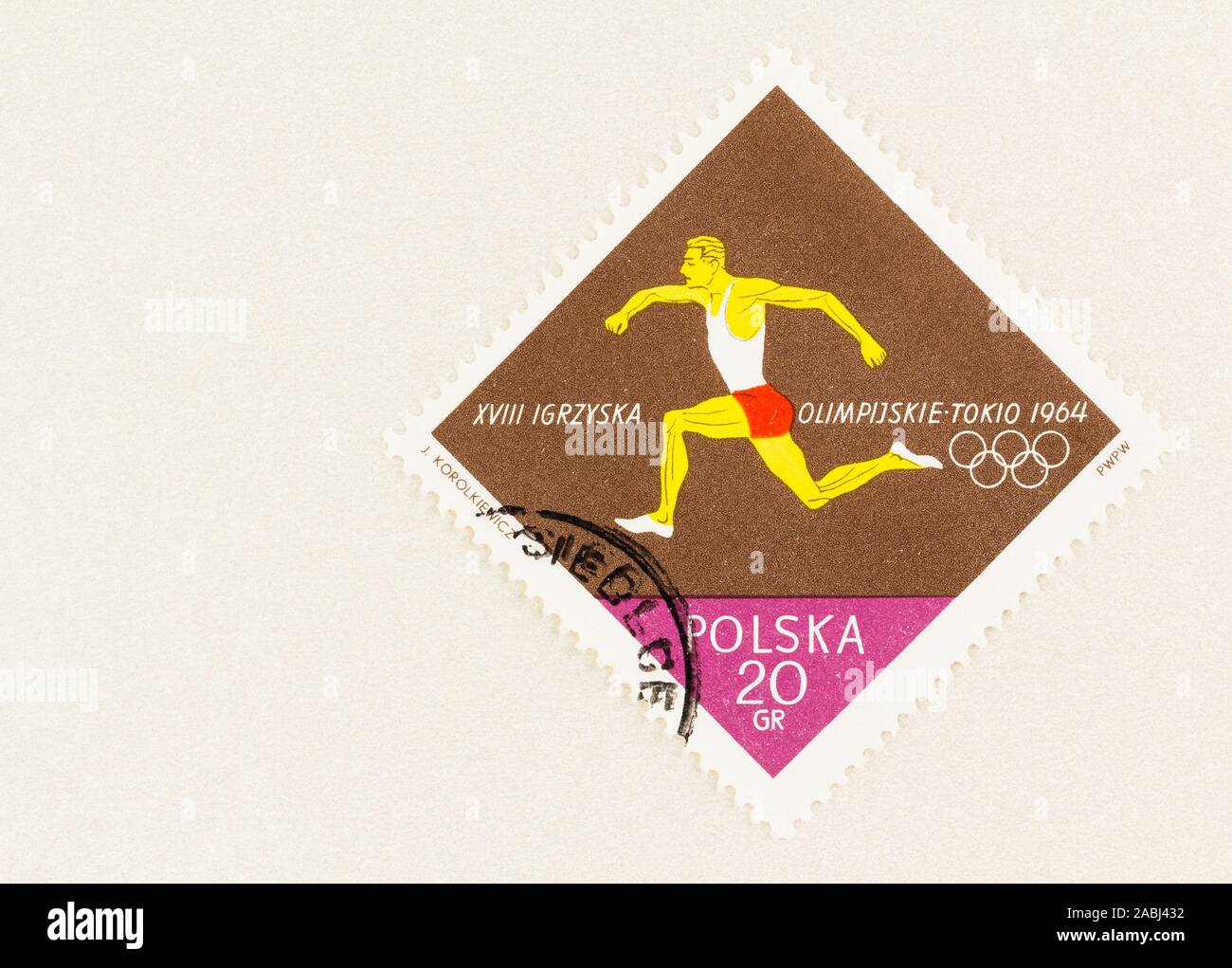 SEATTLE WASHINGTON - October 9, 2019: Polish stamp Olympic runner on brown block of colour and copy space, commemorating the 1964 Tokyo Games. Stock Photo