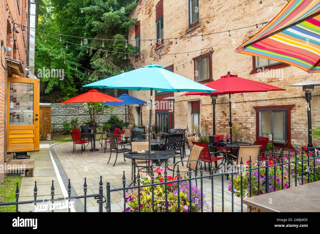 A colorful outdoor patio sidewalk cafe in the historic city of Wallace, Idaho, in the Silver Valley area of North Idaho, USA Stock Photo