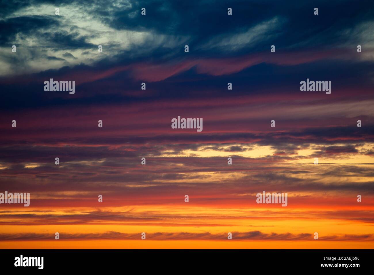 Multicolored dramatic Stratocumulus clouds at sunset. Stock Photo