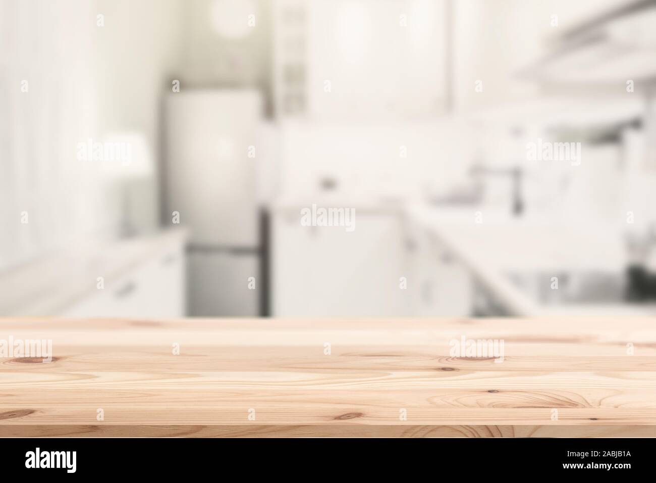 Wooden table top island with blur kitchen home background for products montage advertising. Stock Photo