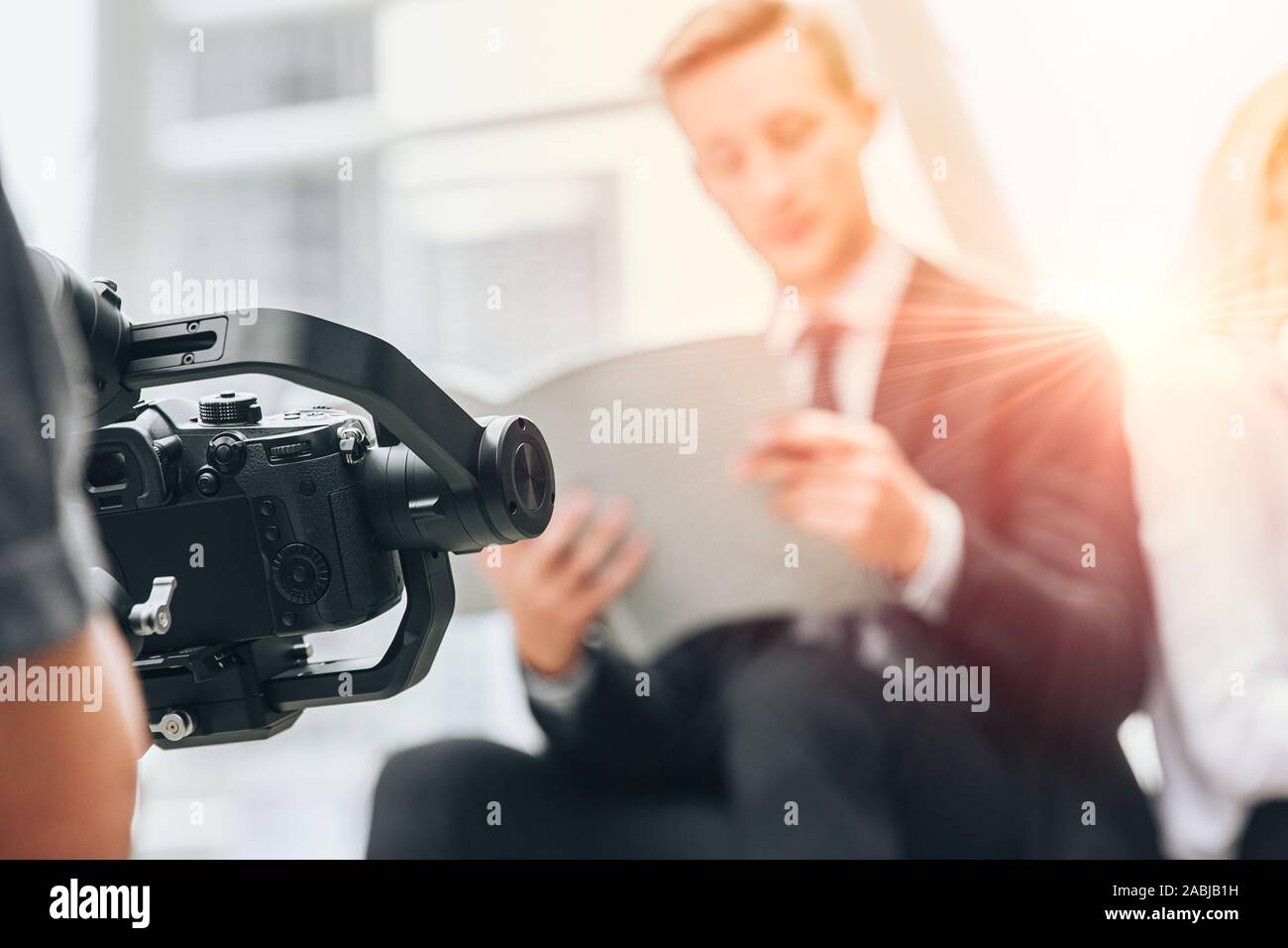 Videographer professional shooting record video usign gimbal camera stabilizer for anti shake device technology in businessman scene. Stock Photo