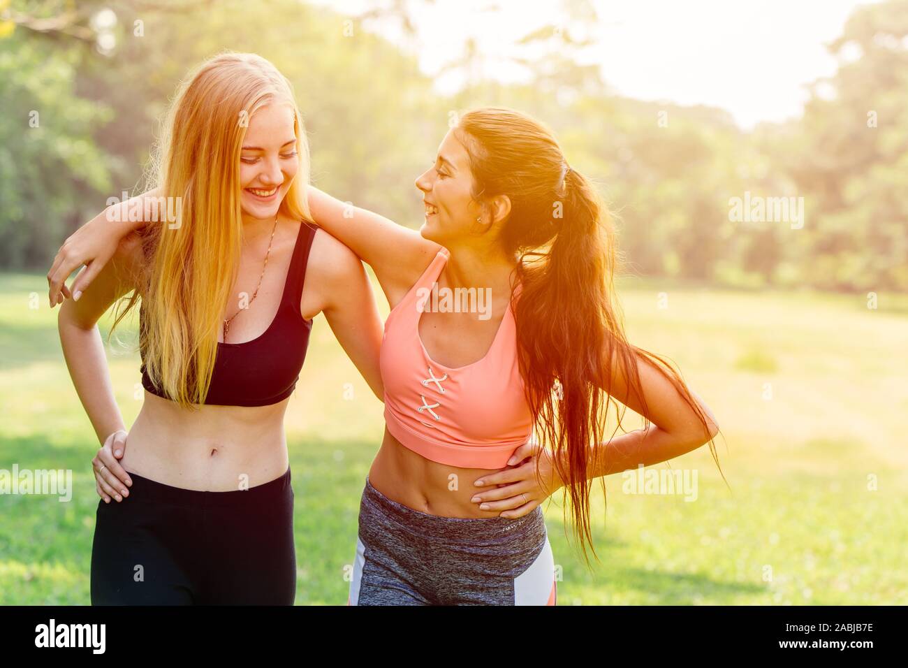 sport healthy girl friends exercise happy talking walking to enjoy healthy lifestyle together in the morning sunrise. Stock Photo