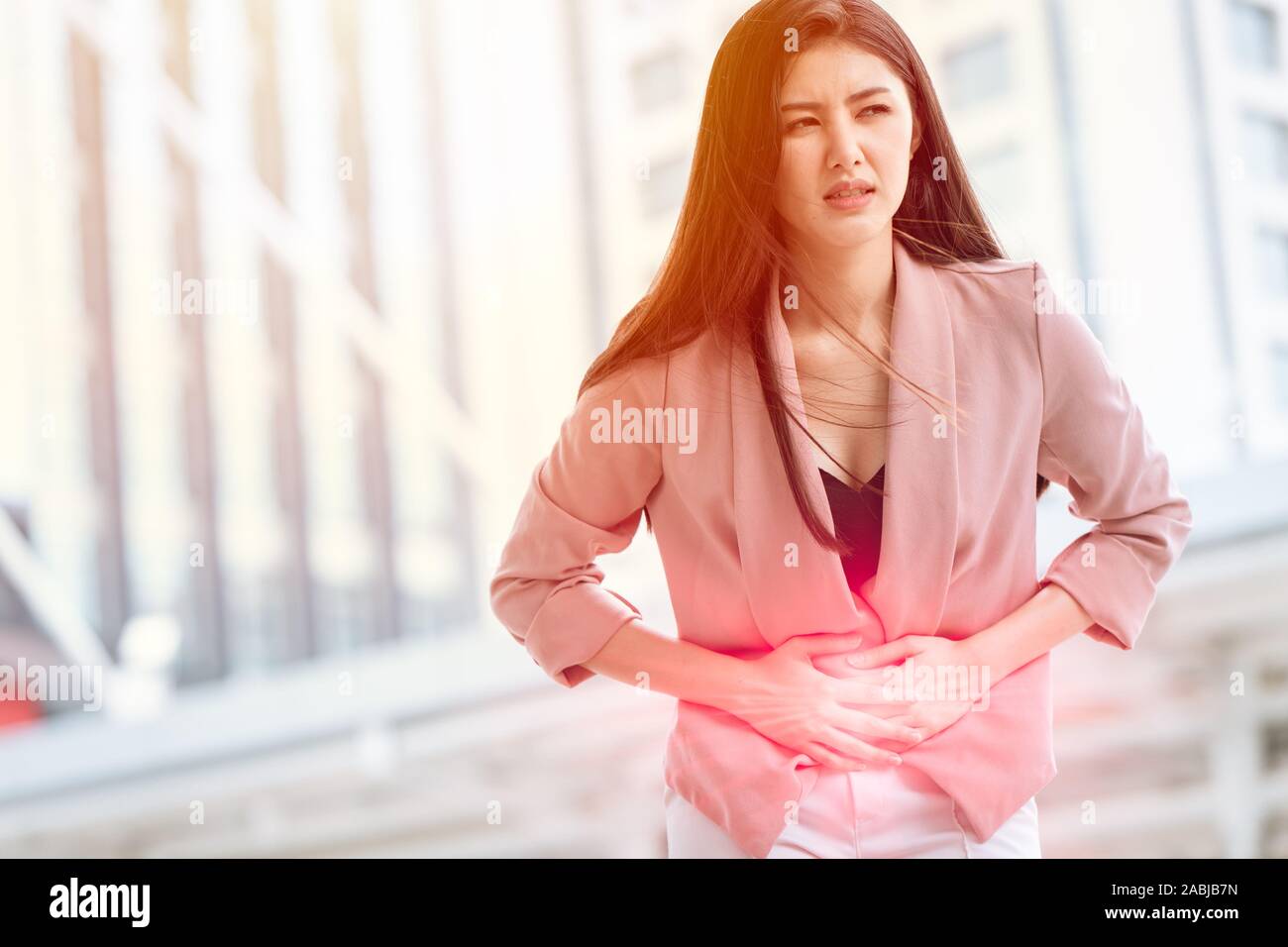 Asian woman front stomach painful sign of Ovarian Endometriosis and Chocolate Cyst syndrome. Stock Photo