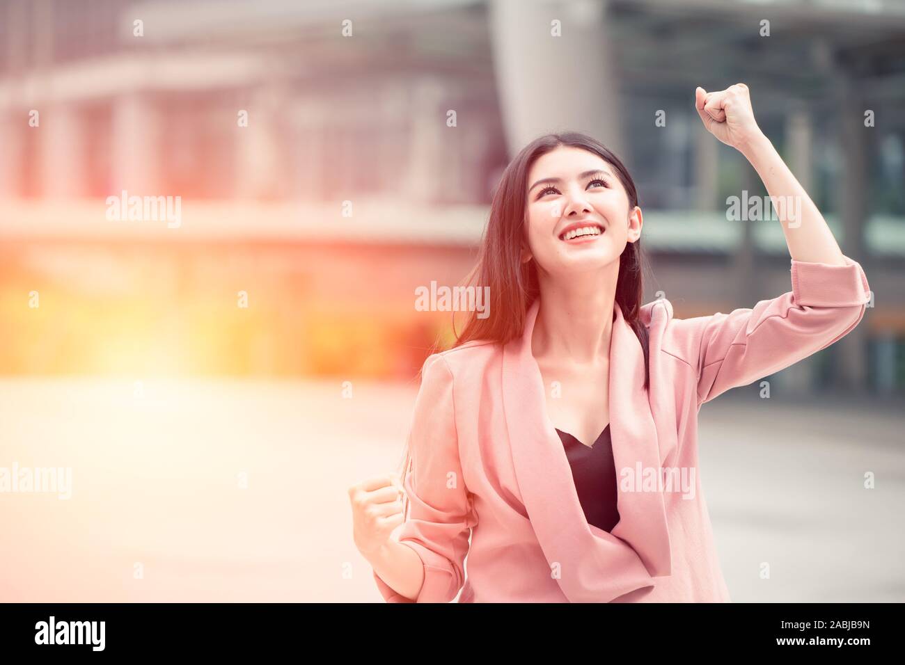 Asian business girl hand rising for winning winner business trading challange successful working. Stock Photo