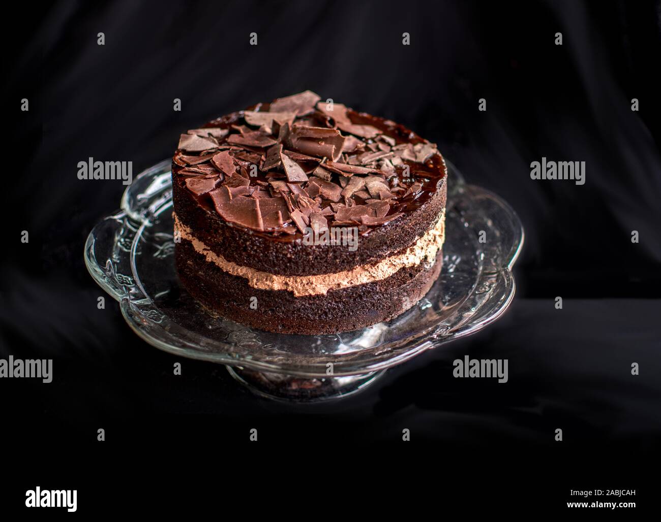 A delicious, two layered cake is decorated with a chocolate glaze ...