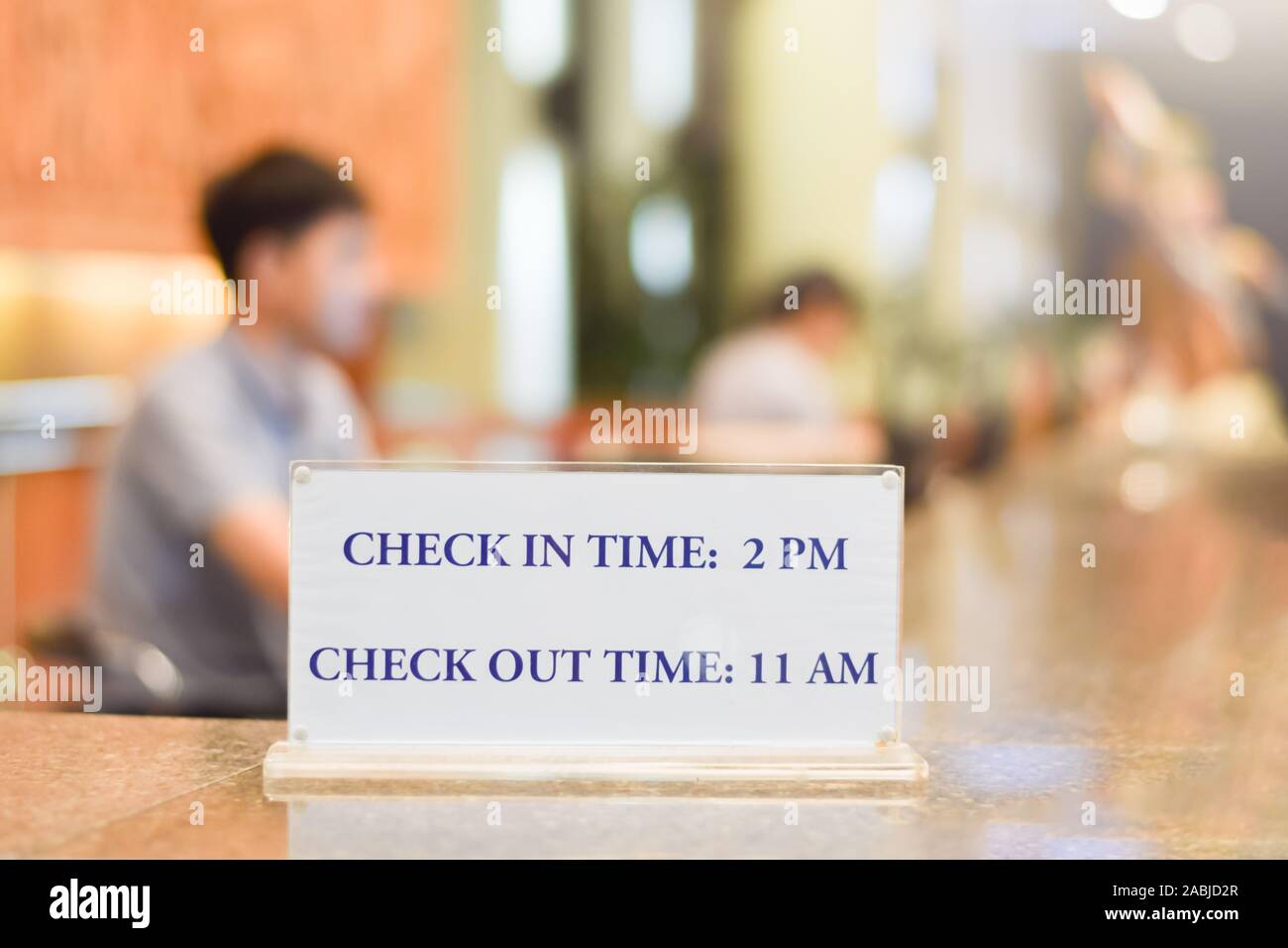 Check in and Check out time at Hotel Reception Counter Close up night time Stock Photo