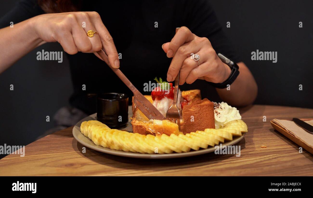 Brown hands holding fork knife hi-res stock photography and images - Alamy