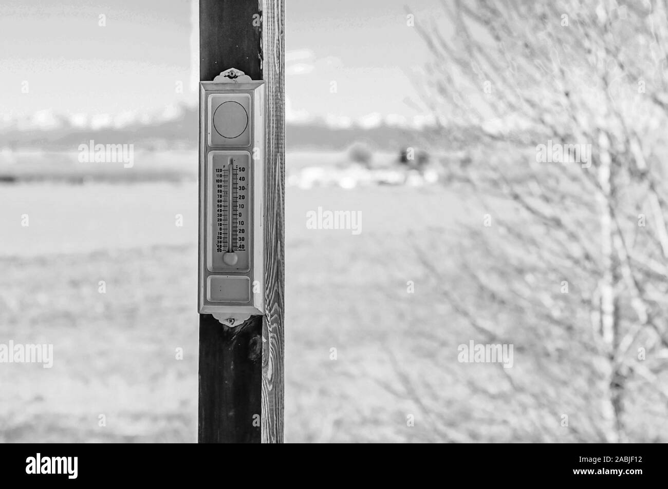 Vintage analog outside thermometer in a black and white photo in winter Stock Photo