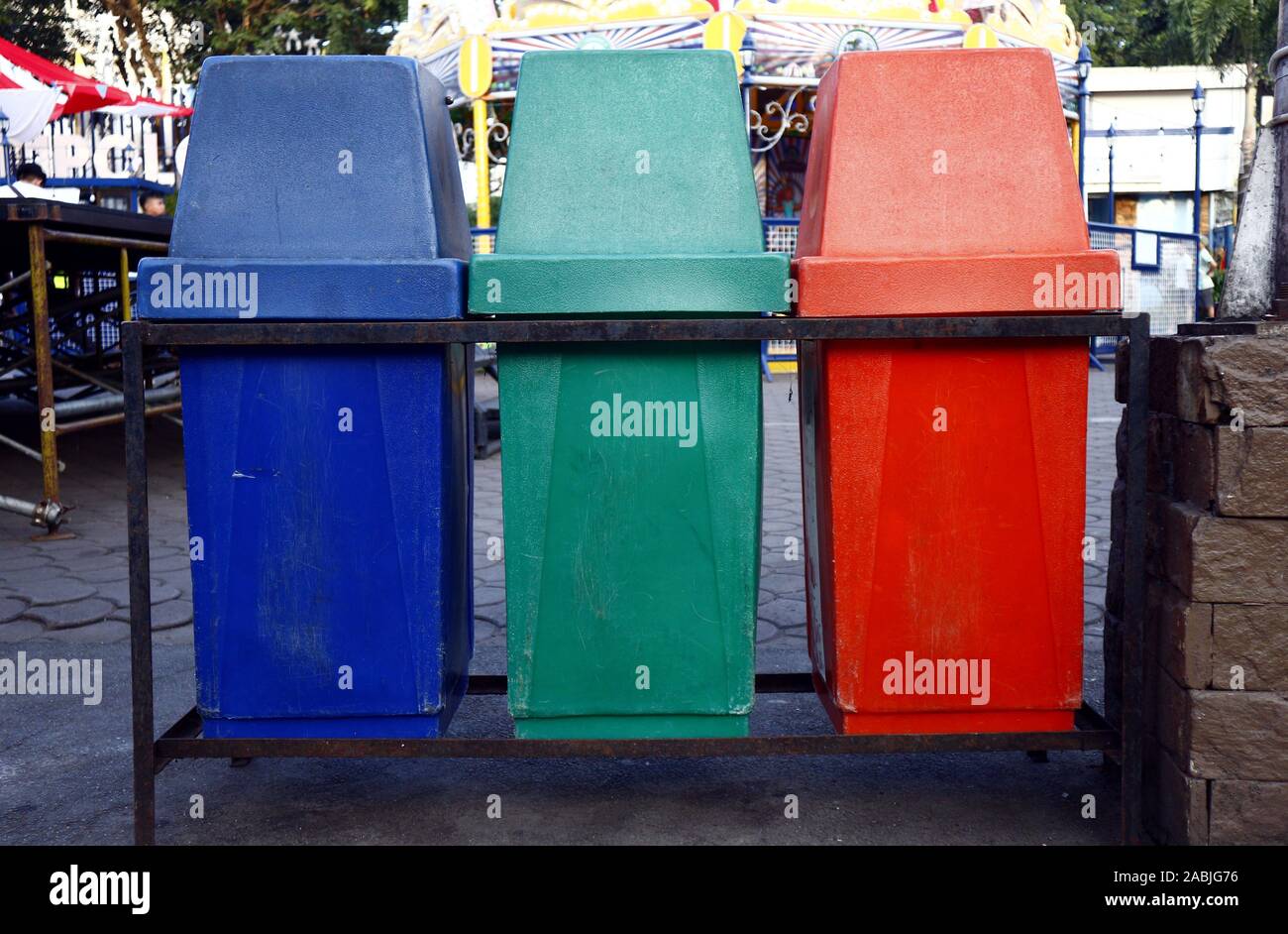 Photo of color segregated garbage or trash bins used for recycling